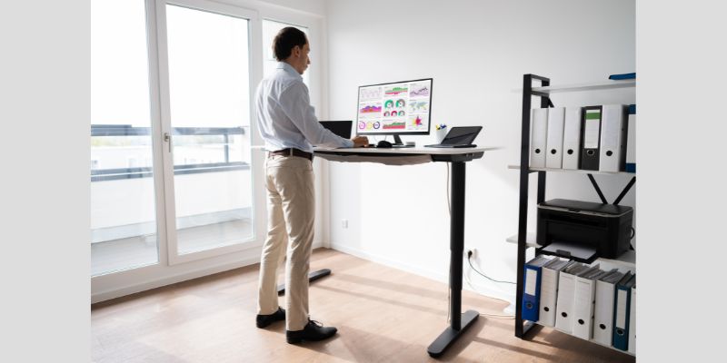 A man working on a standing desk