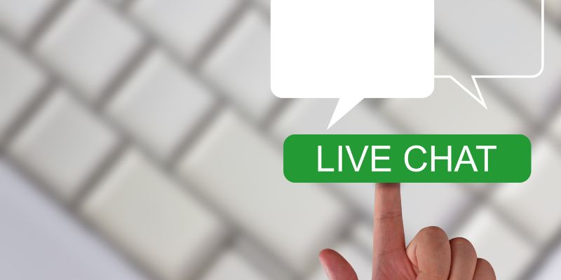 A finger pointing to the live chat icon 